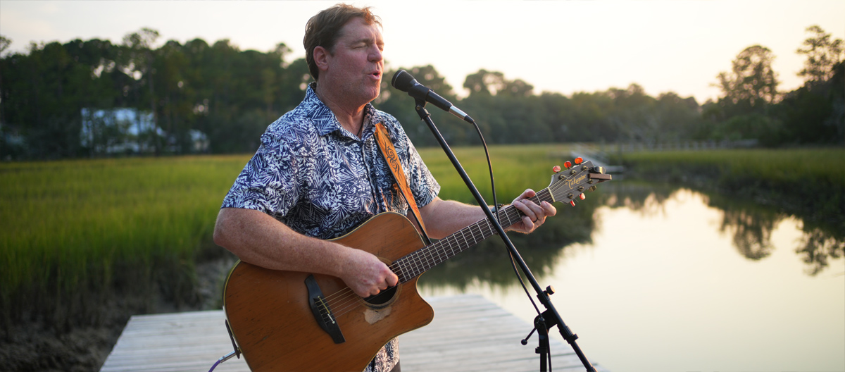 Travis Allison performing guitar and vocals